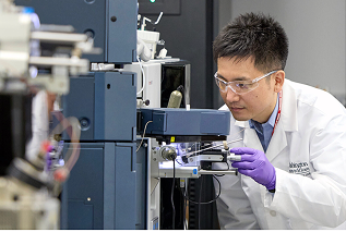 scientist at microscope